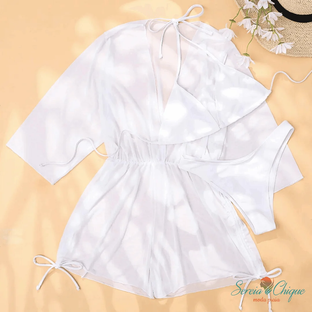 White Daniela three-piece set laid flat showing triangle bikini top, matching bottoms and sheer cover-up with side ties