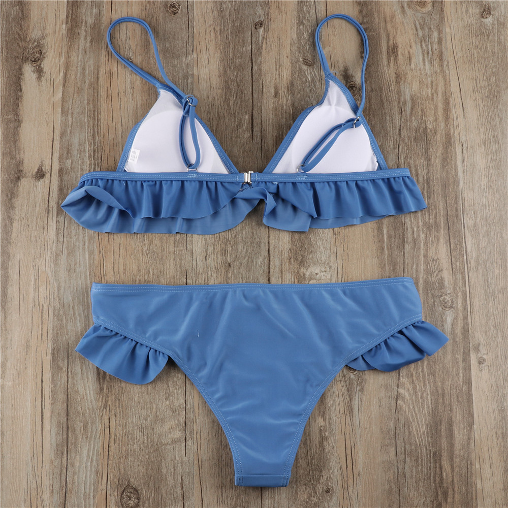 Reverse flat-lay of blue bikini showing white inner top panels, strap adjusters, back fastening and rear of bottoms